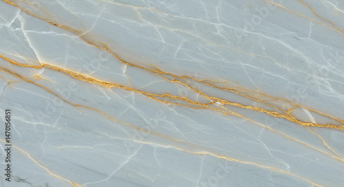 Close up of light blue marble with gold veins running diagonally across the surface of the stone slab