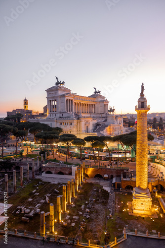 Photography Magnificent sunset view of Trajans Column and the Altare della Patria in Rome