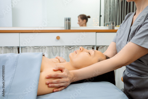 Facial massage for a young woman. Cosmetology procedures for face and body skin. Skin care in adulthood. Horizontal photo of people. Massage of a girl