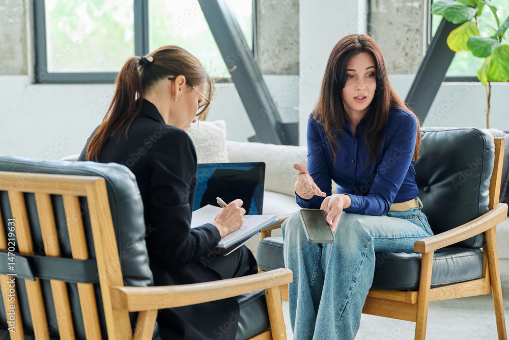 Fototapeta premium Young woman patient in mental therapy session, having professional help psychologist