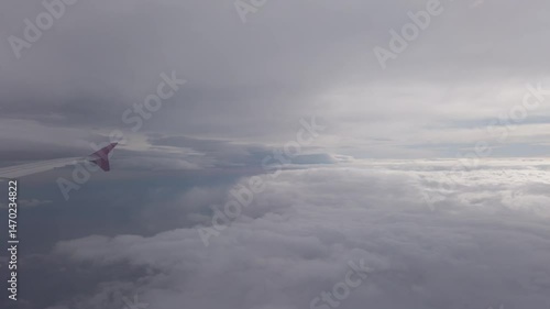 Airplane flight in white cloud at sky. Fly in soft clouds, looking from air plane window