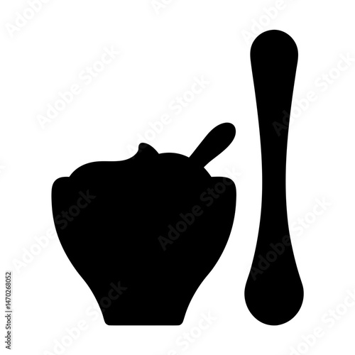 Monochrome bowl of food with a spoon, including a spoon aside