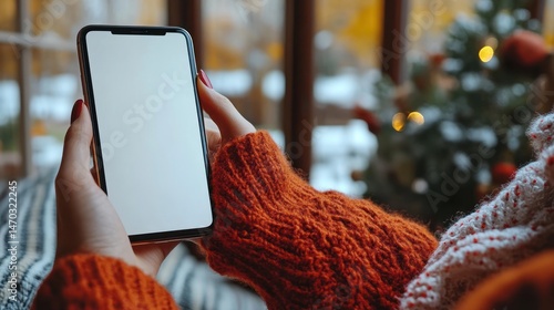 Woman using a phone, cozy winter scene