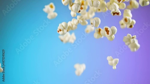 Slow motion popcorn falling down — fluffy kernels in free fall, showcasing cinematic snack vibes, perfect for movie night themes, food ads, and dynamic food visuals.