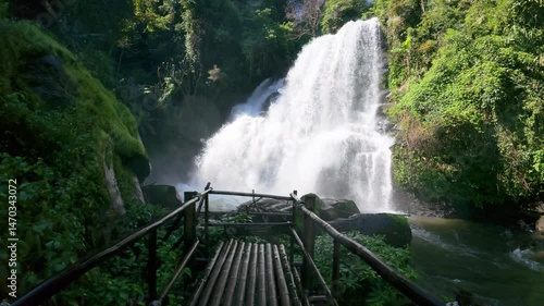 The Pha Dok Seaw Waterfall in Chiang Mai, Thailand, offers a serene view, with lush forest and flowing water enhancing the peaceful atmosphere.