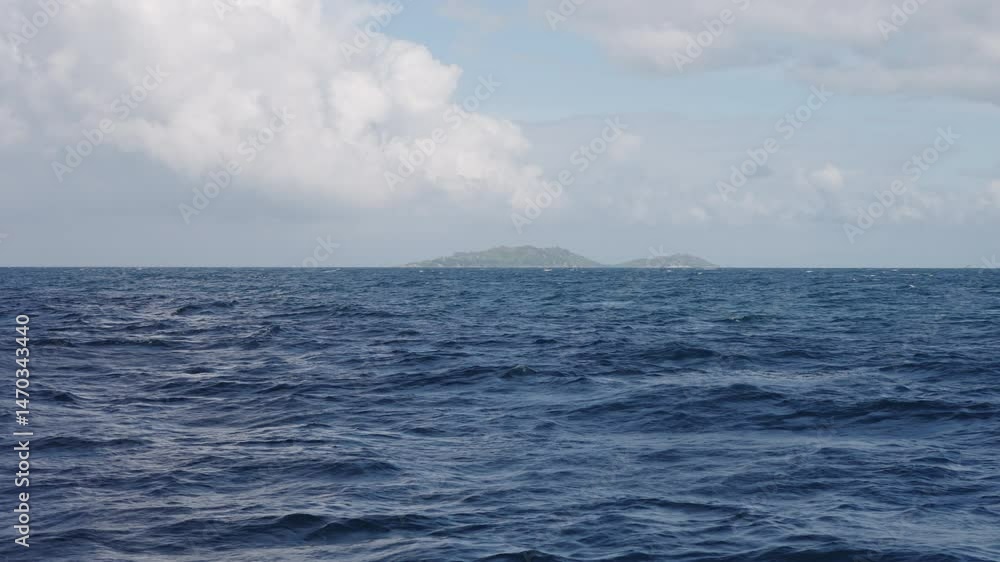 Slow motion side view from boat in Indian ocean sailing between Seychelles islands in daytime Slow motion side view from boat in Indian ocean sailing between Seychelles islands in daytime