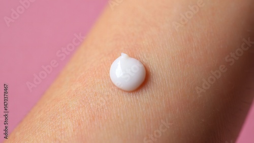 Close up of a dollop of white cream on skin