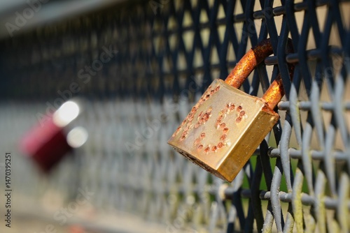 a padlock attached to the railing of a bridge as a sign of lasting love