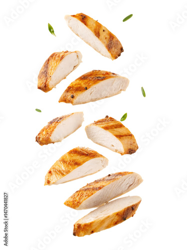 Juicy grilled chicken breast slices falling with fresh herbs Delicious