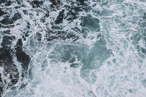Fototapeta Naklejka Na Ścianę i Meble -  Captivating ocean waves with foamy patterns and turbulent sea texture