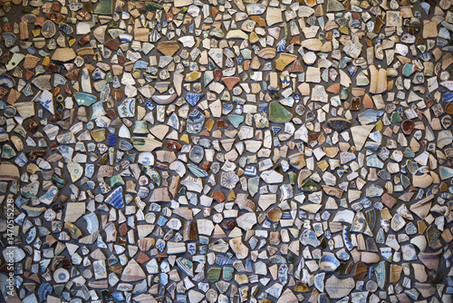 Colorful mosaic wall composed of ceramic shards and patterns creating abstract art