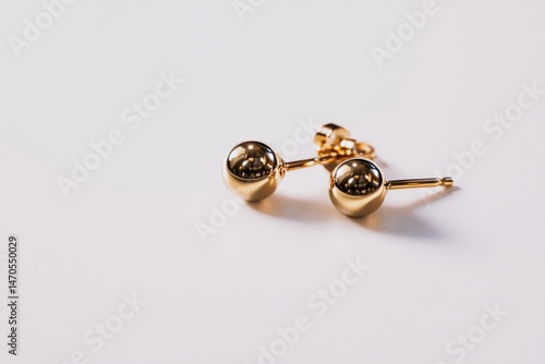 Elegant gold ball stud earrings on a white background.