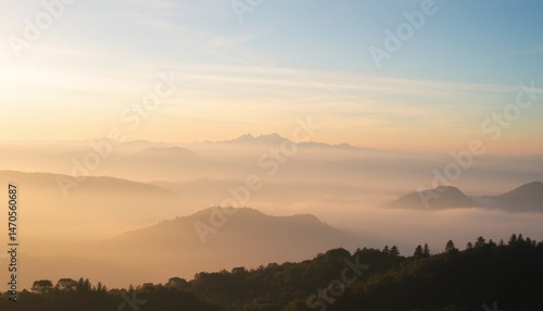 Wallpaper Mural Panoramic vista of a mountainous landscape shrouded in dreamy morning fog, bathed in the golden light of sunrise with soft gradient sky Torontodigital.ca