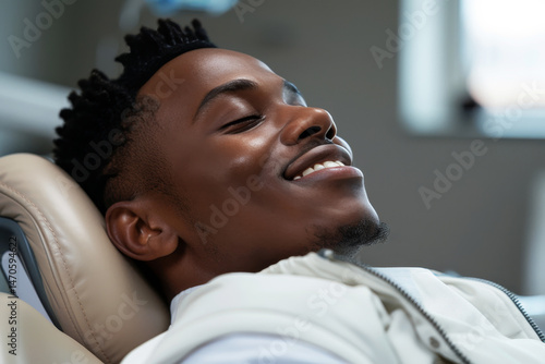 Close up of confident man smiling with bright white dental veneers in dentist chair setting