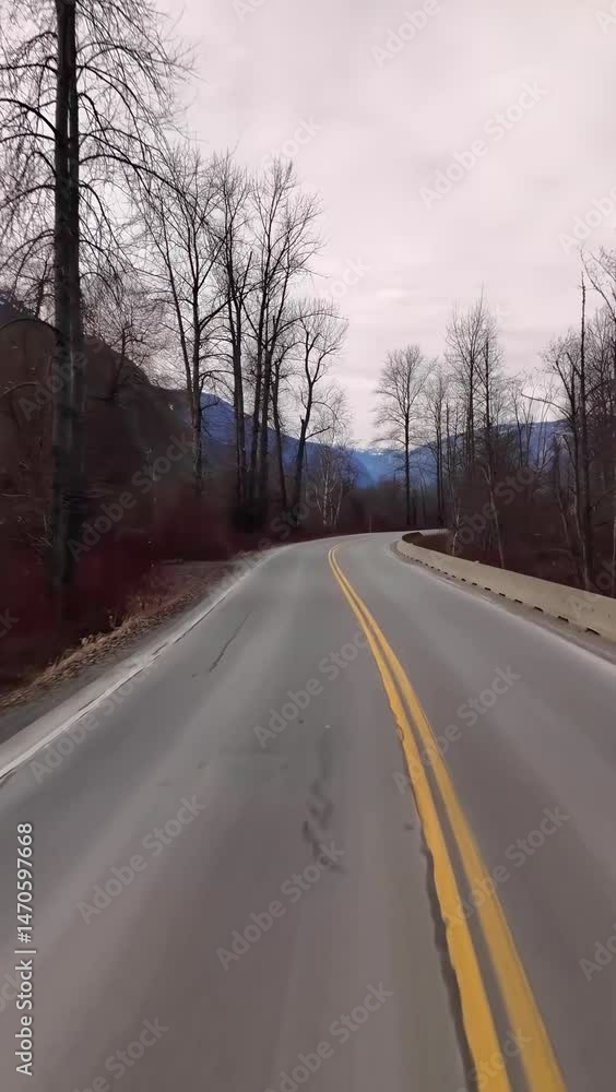 Driving Down a Winding Mountain Road in British Columbia, Canada on an Overcast Winter Day Driving Down a Winding Mountain Road in British Columbia, Canada on an Overcast Winter Day