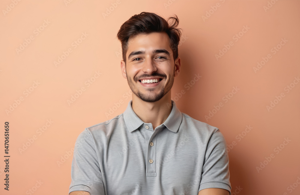 Young man in his twenties wears gray polo shirt. Attractive guy smiles on pastel background. Represents preppy style. Suitable for business casual. Pro portrait. Young man in his twenties wears gray polo shirt. Attractive guy smiles on pastel background. Represents preppy style. Suitable for business casual. Pro portrait.