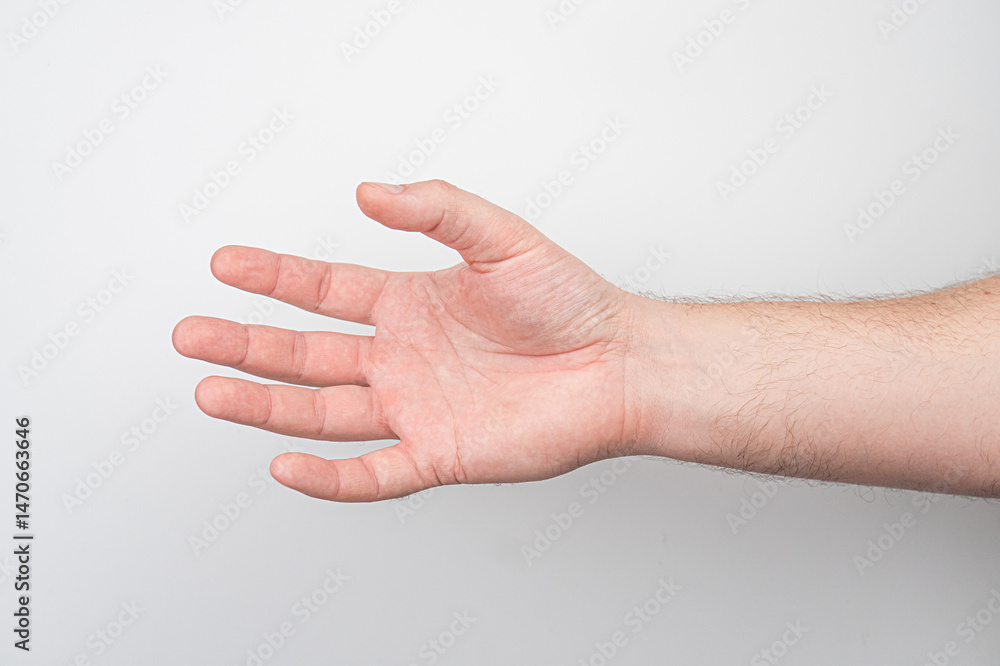 Close-up photograph of an older hand, open palm and slightly curled fingers, against a plain background. Close-up photograph of an older hand, open palm and slightly curled fingers, against a plain background.