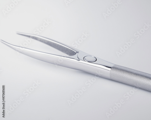 Stainless steel dental pliers on white background, close-up
