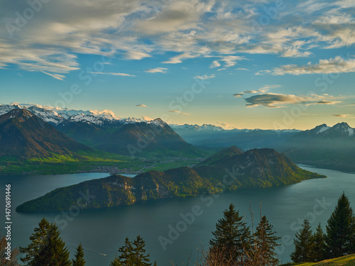 Photography Breathtaking view of mountains and lake during golden hour near a picturesque is