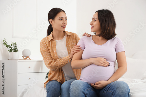 Young Asian doula with preg...