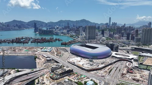 Aerial view of Kai Tak Sports Park construction in Hong Kong, showcasing CBD commercial buildings, urban residences, retail, leisure parks, and modern stadium sports and recreation facilities