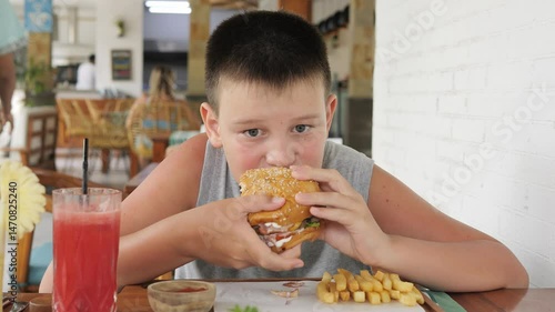Child consuming fast food in cozy cafe highlights serious harm of unhealthy eating habits Harm from poor nutrition begins early Scene emphasizes emotional and physical harm linked to food behavior