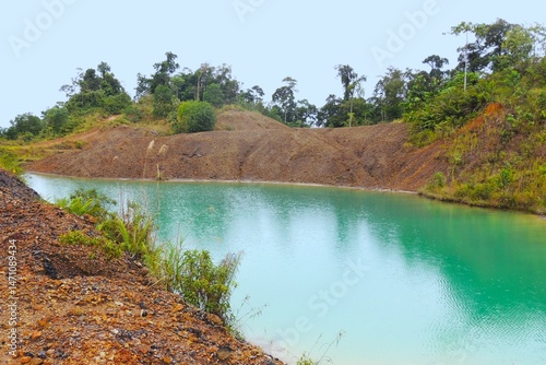 Fotografie Former illegal coal mining activities that have been abandoned and eventually became an artificial lake, and must be rehabilitated to protect the environment