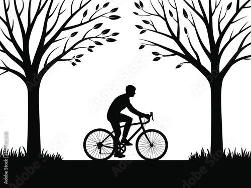 Silhouette of a cyclist riding a bicycle along a path between two trees in nature