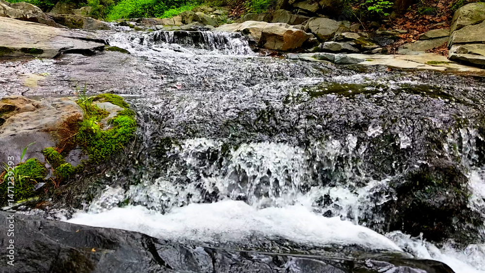 Obraz premium Valley for Summer Vacation ,Slow Motion ,Clear Stream flowing over rocks and rocks ,Rich Valley in slow motion ,Crystal clear water spills over rocks ,Silent natural scene ,Silent flowing riverbed