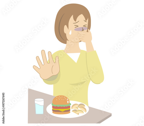 胃がムカムカして口を手で抑え食事を食べることができない若い女性	