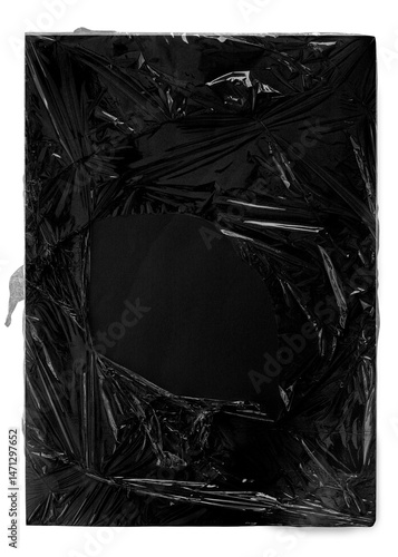 A high-resolution abstract texture featuring a torn plastic film wrapping around a solid black background with a central exposed area. This grunge-inspired visual is perfect for creative overlays, exp