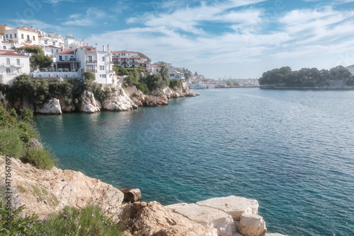 Scenic view of the Skiathos coastline with the old port in the distance.
