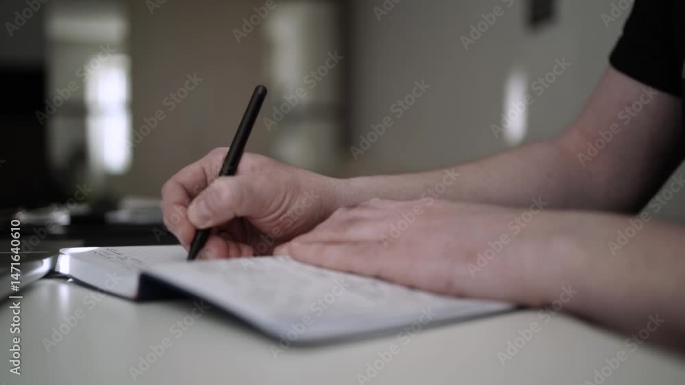 Man Journaling - Focused Handwriting in a Notebook to Self-Help During Depression Man Journaling - Focused Handwriting in a Notebook to Self-Help During Depression