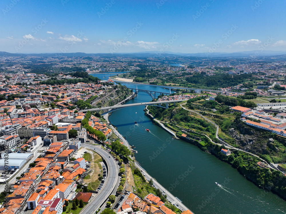 Fototapeta premium Drone view showing multiple bridges over Douro River heading inland
