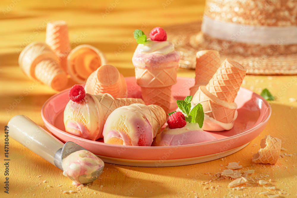 Sweet and delicious raspberry ice cream in a waffle cone.