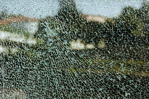 Broken glass with trees in the background