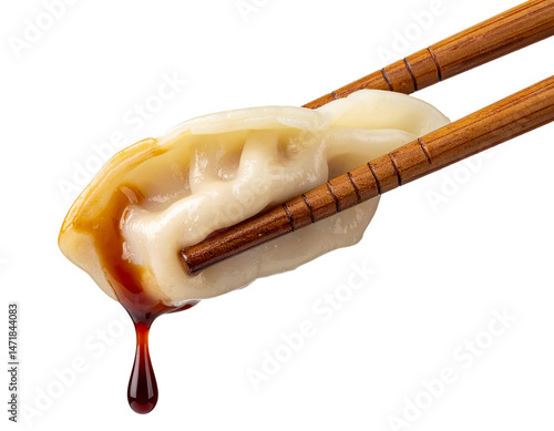 Dumpling with Soy Sauce on Chopsticks Isolated Against Black Background Asian Cuisine