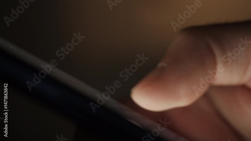 Man Using Mobile Phone in Dark. Finger Scrolling on Screen. Close-up Finger Scrolling Social Media App Feed or Reading News Feed Online. Person Using Smartphone, Browsing at Night. Addiction Insomnia.