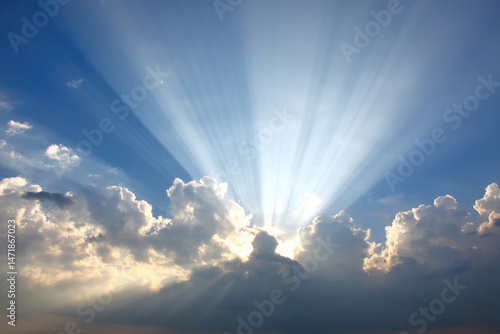 Sunlight streams through fluffy clouds, creating beautiful rays that illuminate the sky. This breathtaking natural phenomenon showcases the beauty of a clear day, making it a moment to appreciate