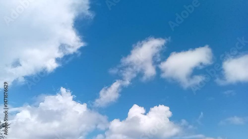 Footage of a bright sky with beautiful white clouds.