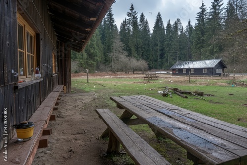 Wallpaper Mural Rustic cabin scene with wooden benches and lush greenery. Torontodigital.ca