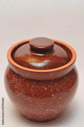 Оne Brown ceramic pot with lid on white background.