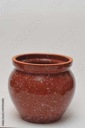 one brown ceramic pot on a white background