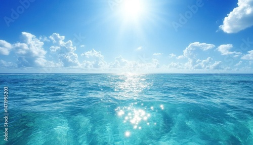 Radiant Ocean View with Azure Water and Clouds Under a Bright Sunlight Blue Sky Reflecting Shimmering Water Creating a Sense of Serenity and Vastness Featuring Tropical Waters
