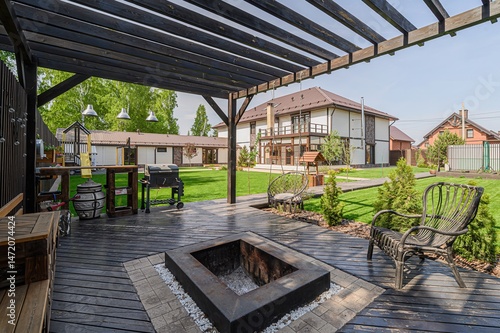 Bild auf Leinwand Outdoor patio with a fire pit, grill, and seating area
