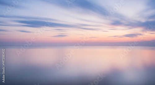 Fototapeta Naklejka Na Ścianę i Meble -  Serene Sunset: Pastel Skies & Reflections Over Tranquil Water - A Beautiful Long Exposure Seascape