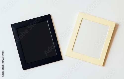 Two empty picture frames, one black and one pale yellow, lie on a white surface, offering a minimalist design element for various projects. : Generative AI
