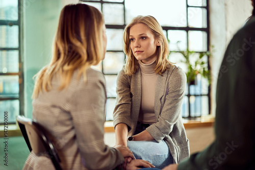 Two Women Sharing an Emotional Conversation in a Bright Room