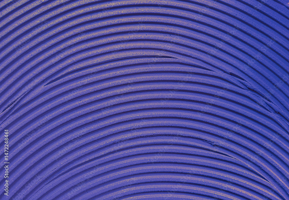 Close-up of violet material with repeating curved grooves pattern.. Close-up of violet material with repeating curved grooves pattern..
