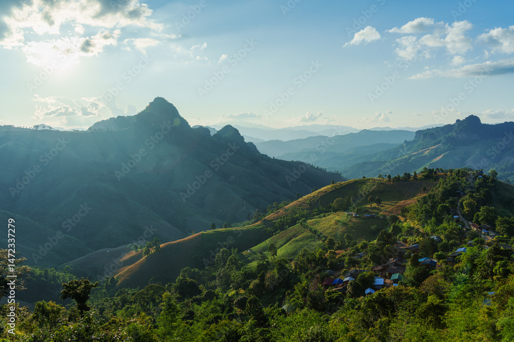 Fototapeta premium Sunlight over local village on mountain in the valley at Gigokor viewpoint